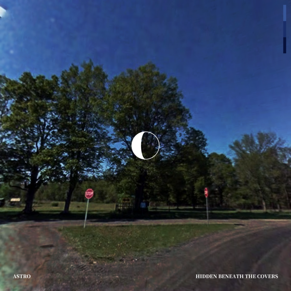 A grainy photograph at a three-way intersection with stop signs in a park. A graphic of a waning crescent moon is in the center.