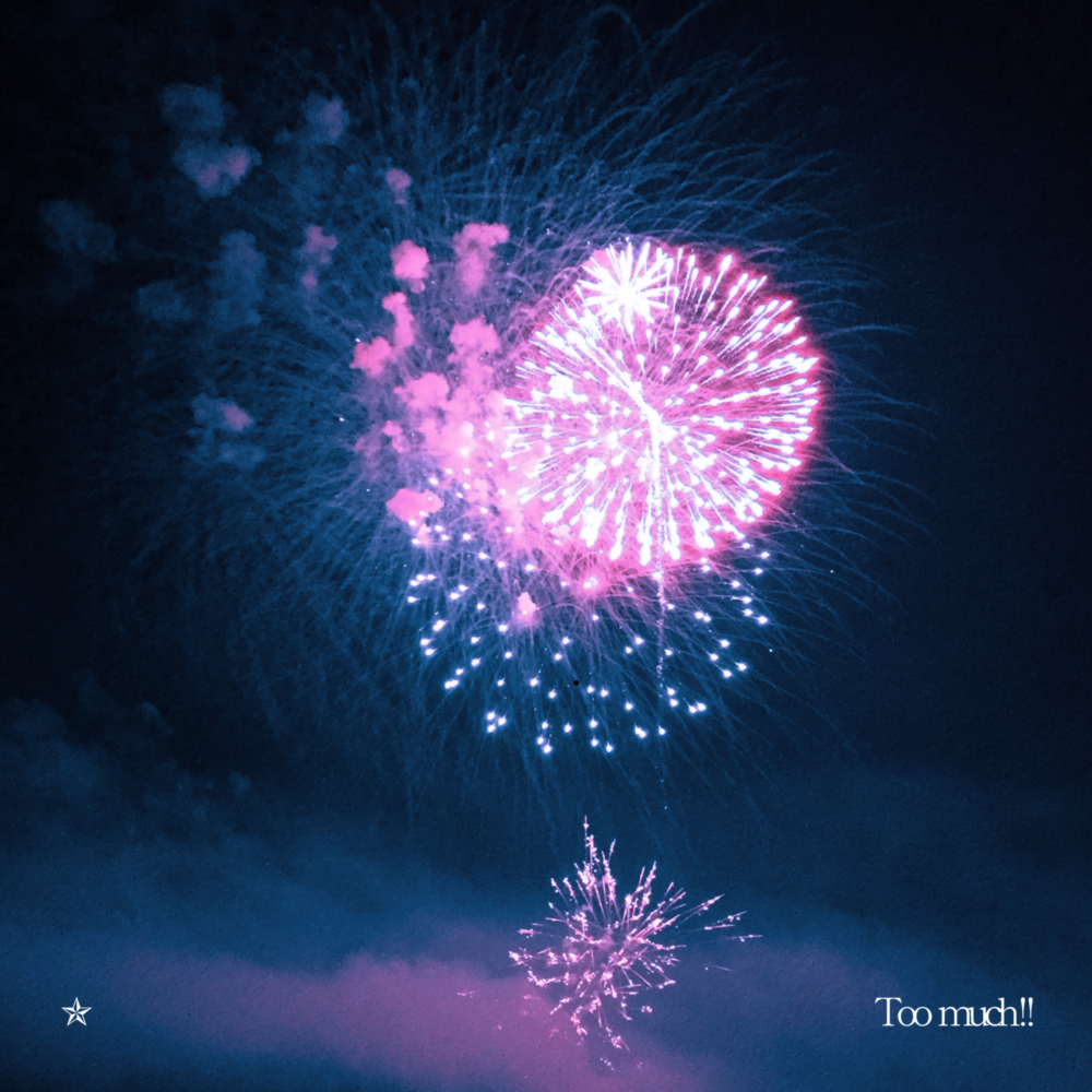 Bright pink fireworks exploding in a dark blue sky.